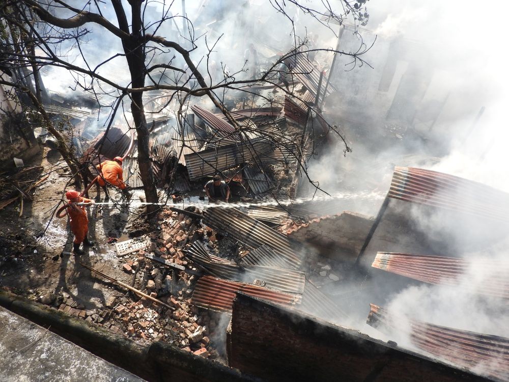 Firefighters dousing the flames in Lhomithi colony on January 3. The fire left five families homeless.